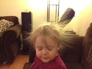 She wasn't swishing her hair.  It was sticking straight out after an encounter with the sofa.
